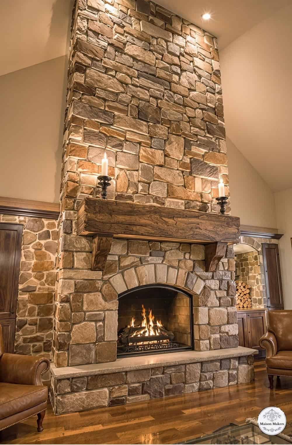 a stone fireplace in a large living room