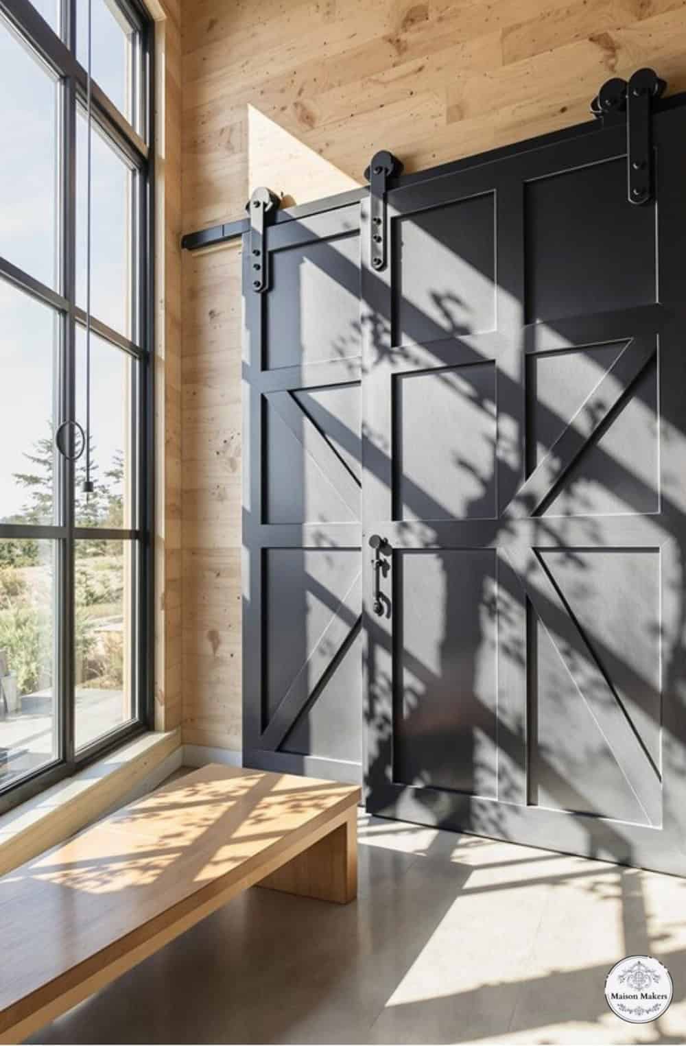 a room with a bench and a large window