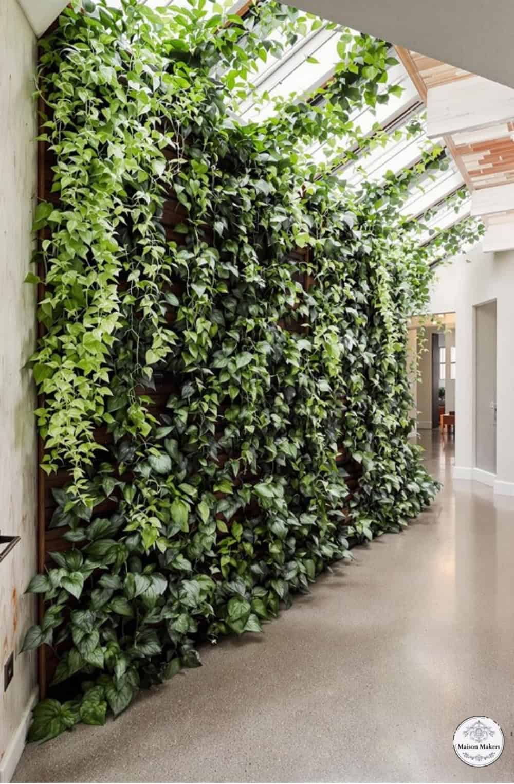 a large green wall with plants growing on it