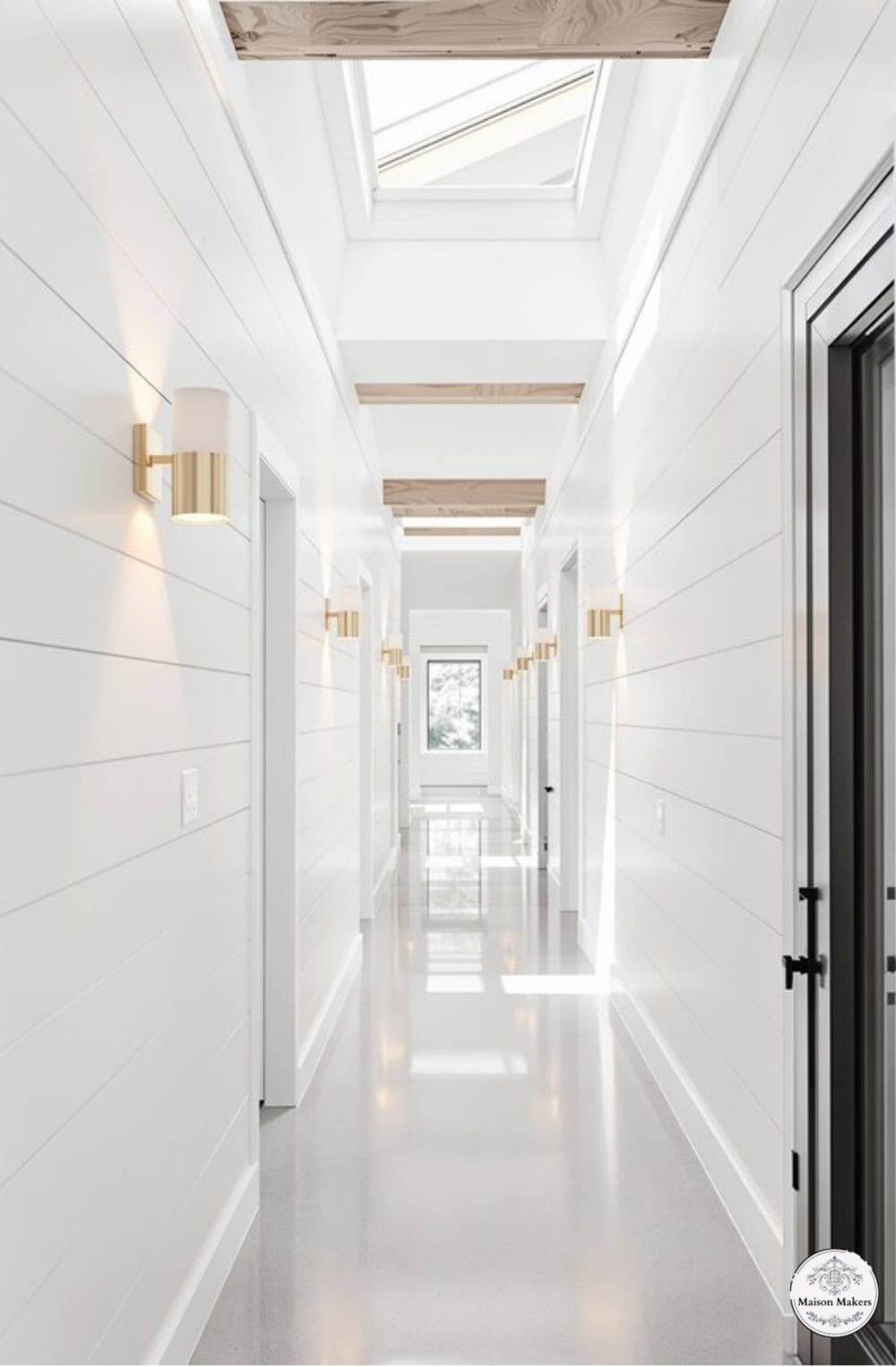 a long hallway with white walls and a skylight