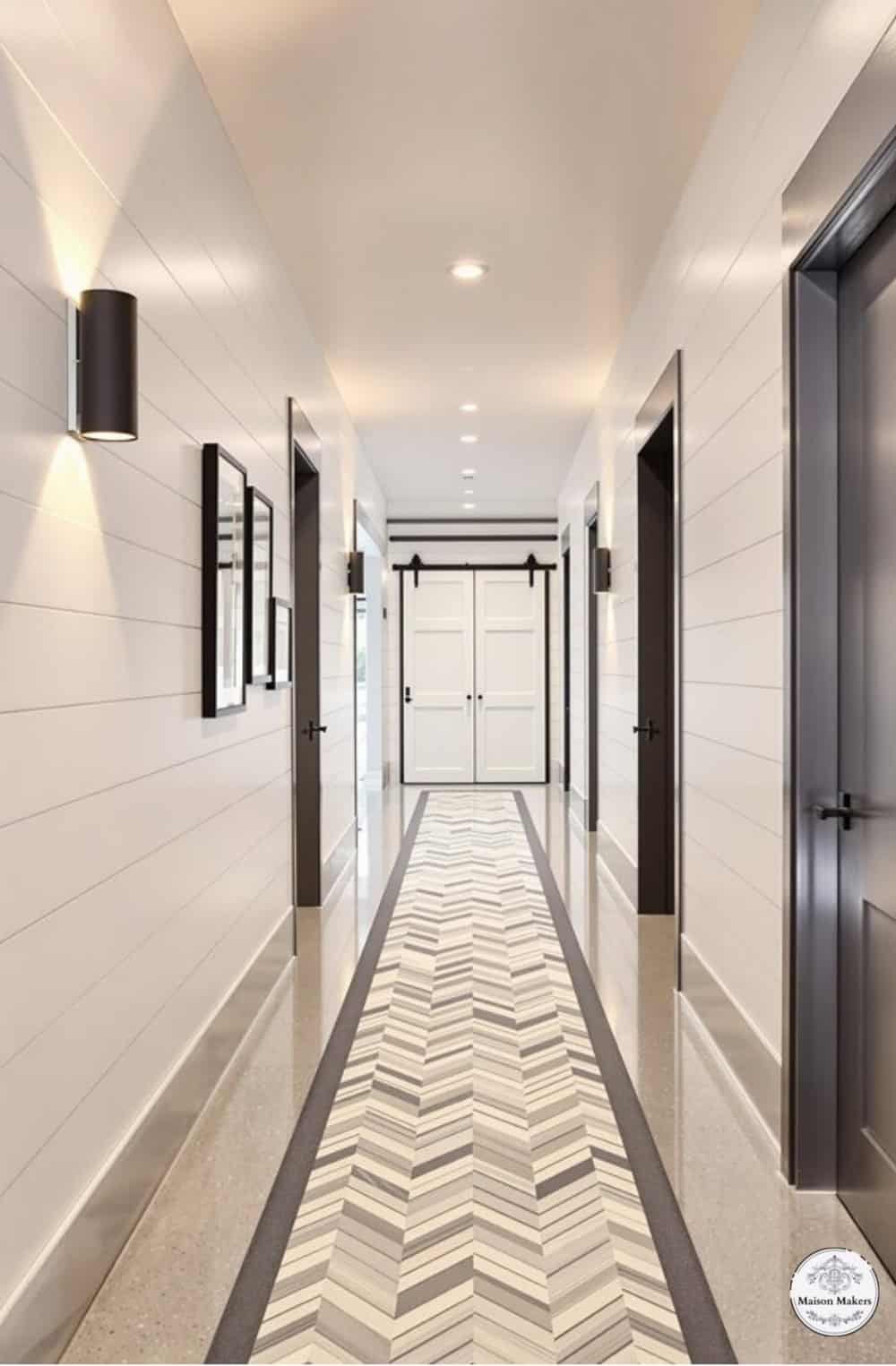 a long hallway with white walls and a black door
