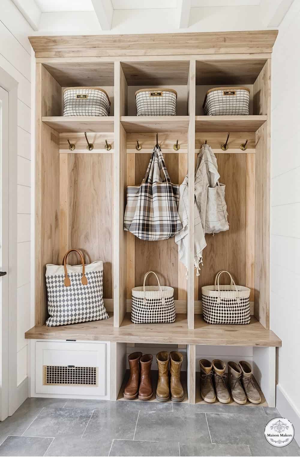 a wooden bench with baskets and bags on it