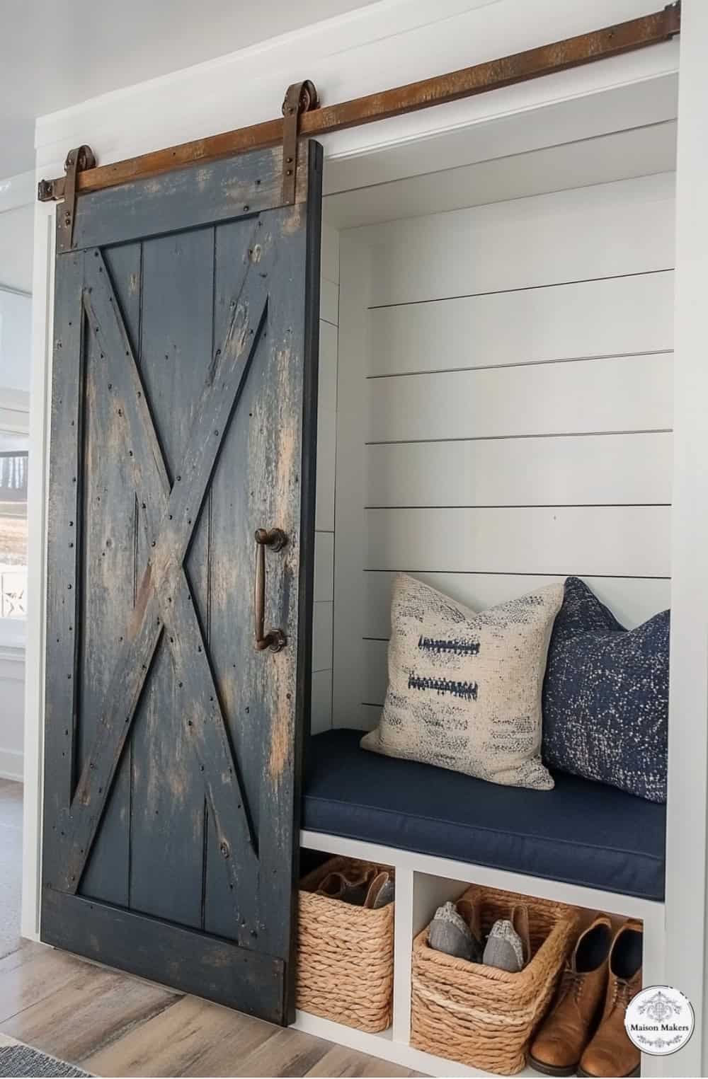 a bench with a blue cushion and a wooden door