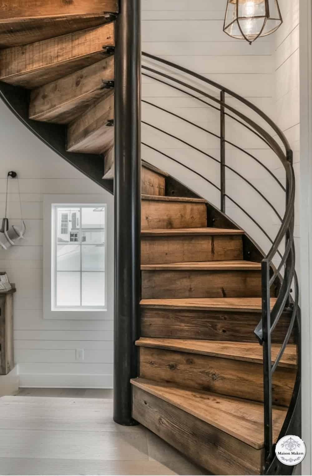 a spiral staircase in a home with white walls
