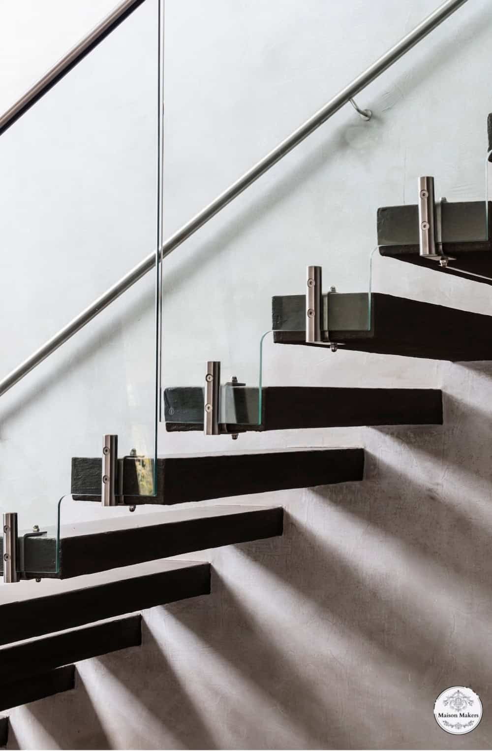 a set of black and white stairs leading up to a skylight