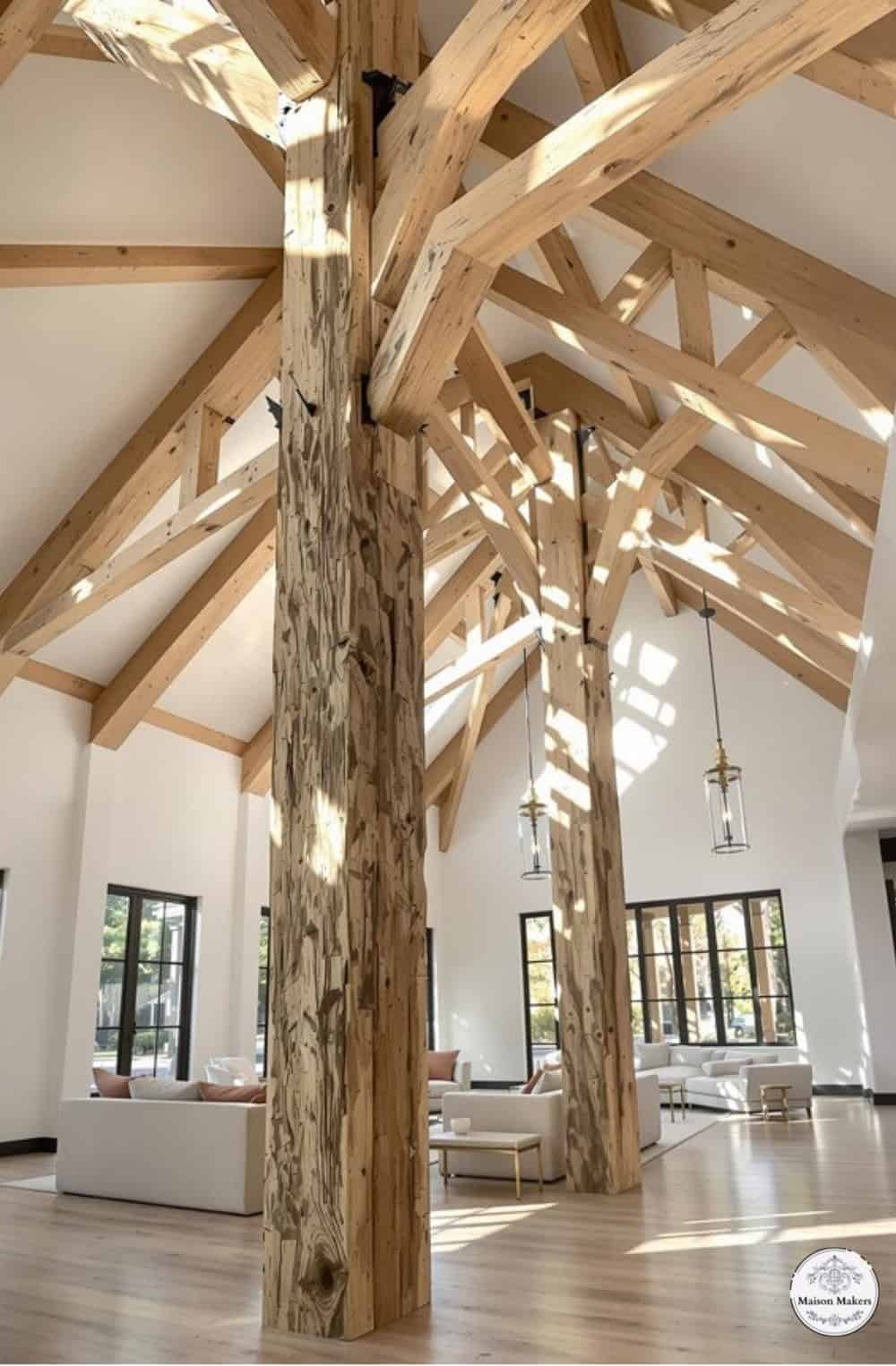 a large open room with wooden beams and windows