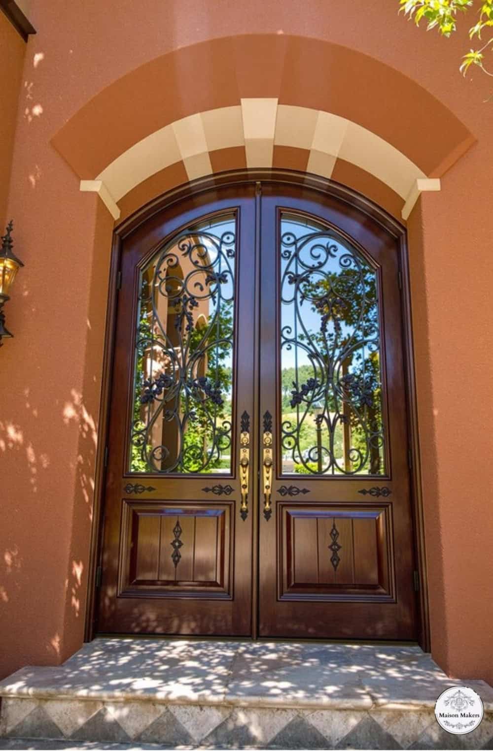 a large wooden door with a glass window