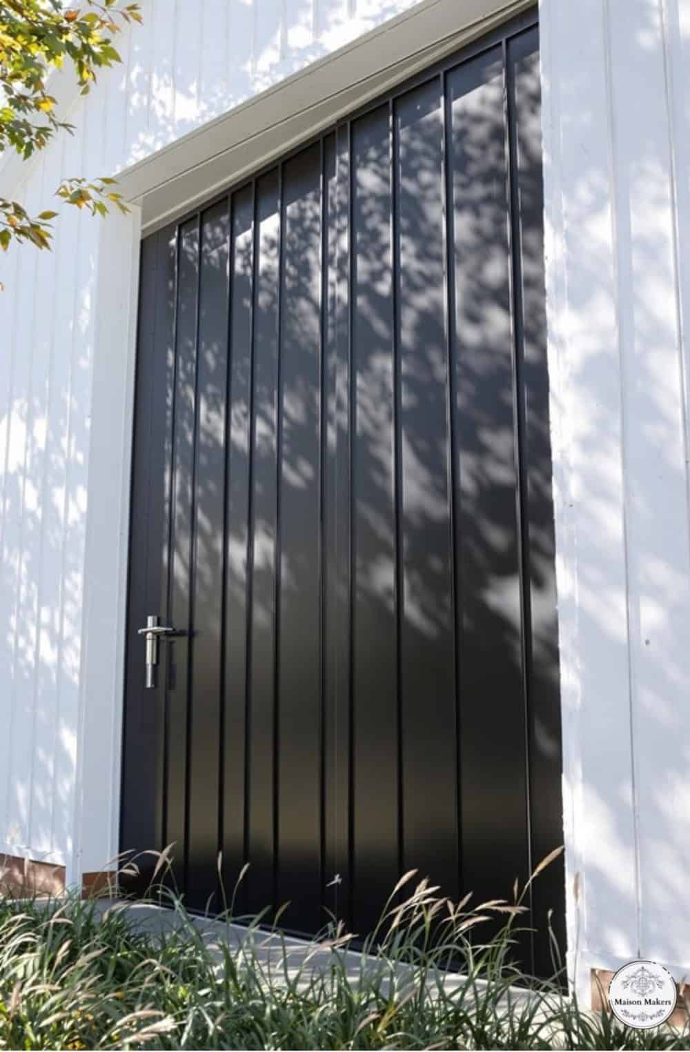 a white building with a large black door
