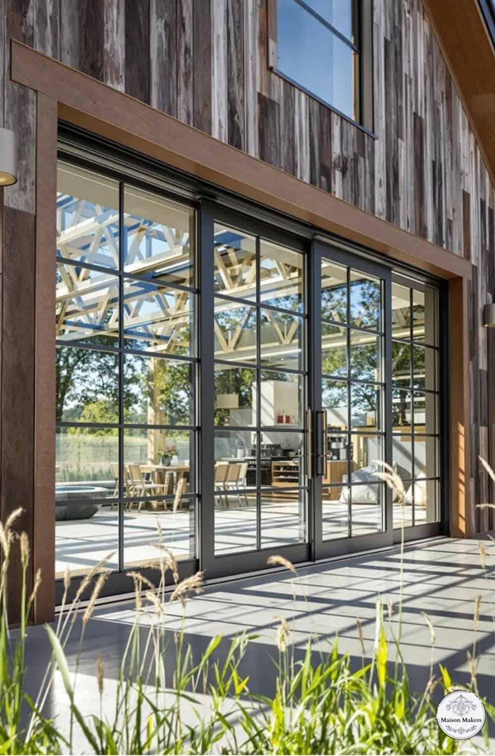 a large wooden building with glass doors and windows
