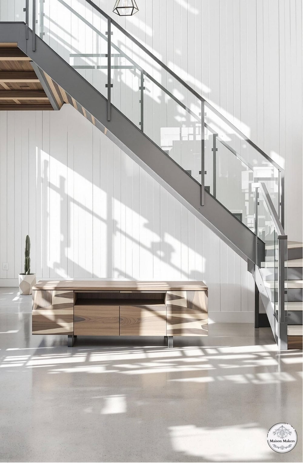 a staircase in a white room with a wooden table