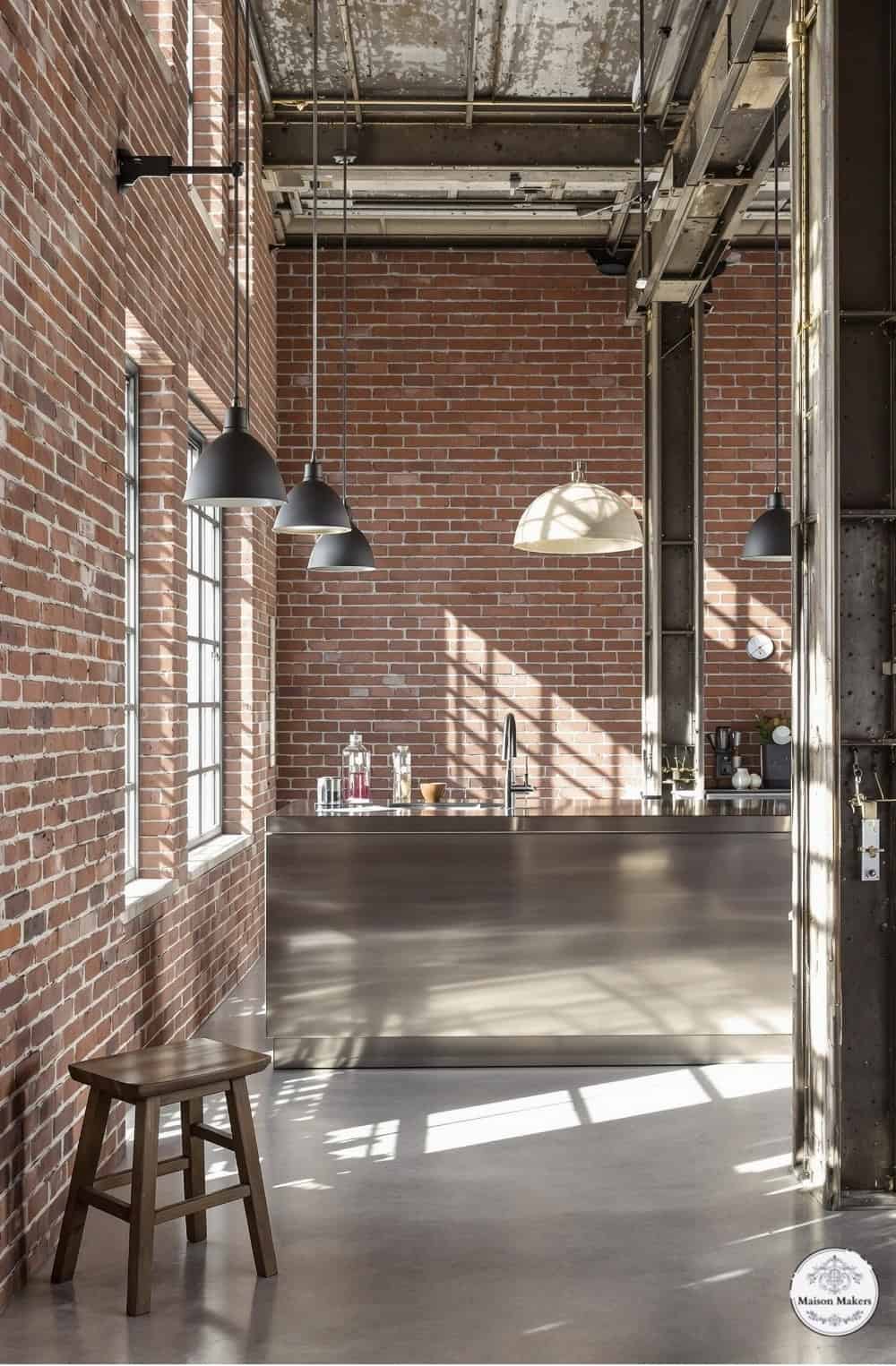 a room with a brick wall and a wooden stool
