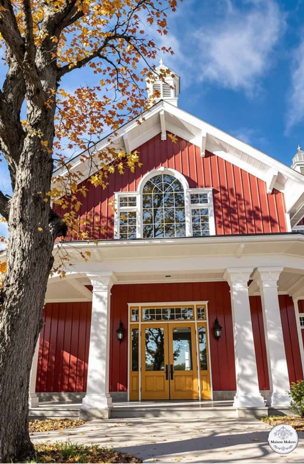 a red and white house with a tree in front of it