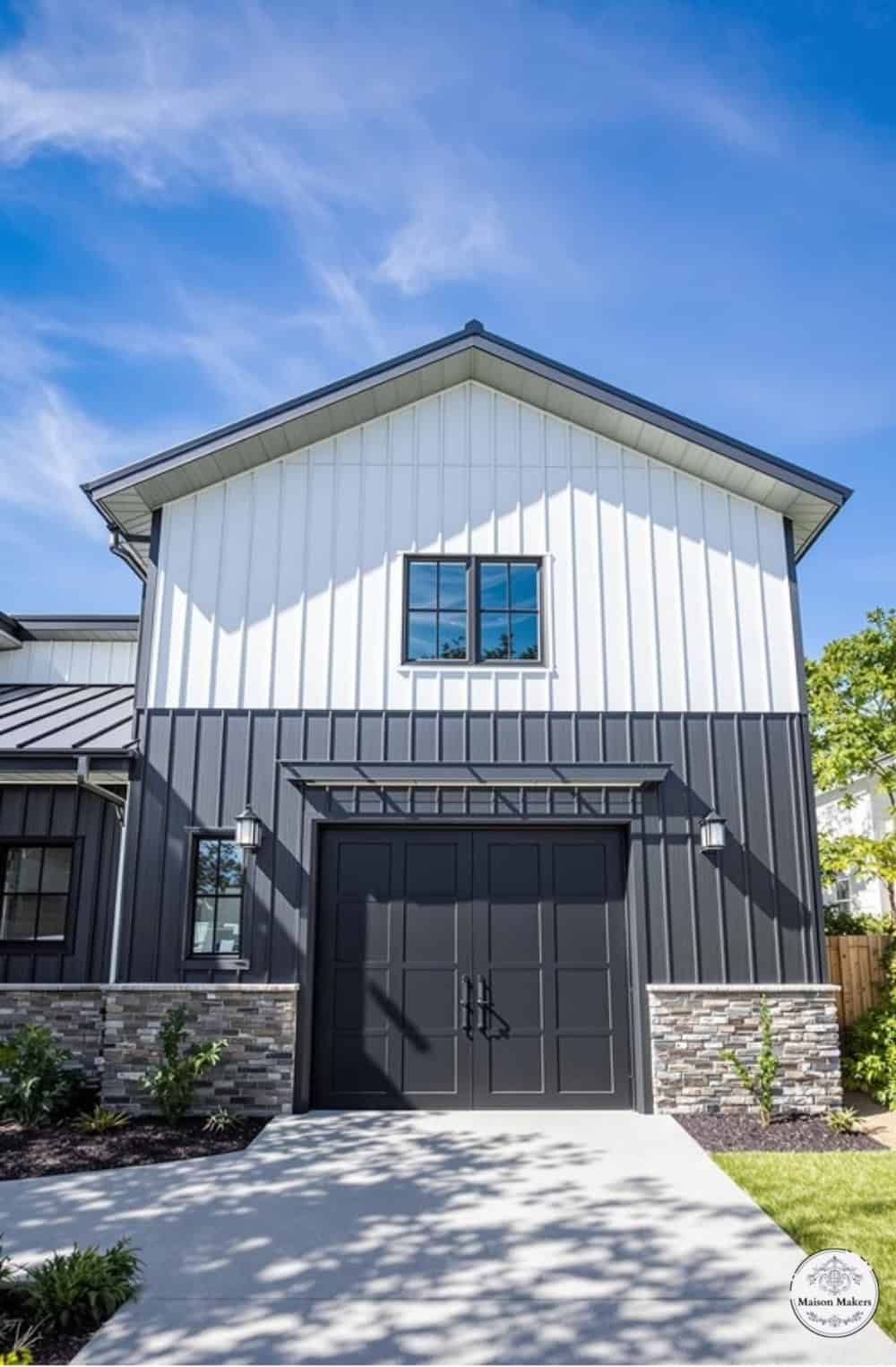 a gray and white house with a black garage door
