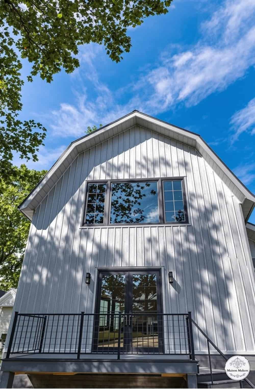 a white house with a porch and stairs