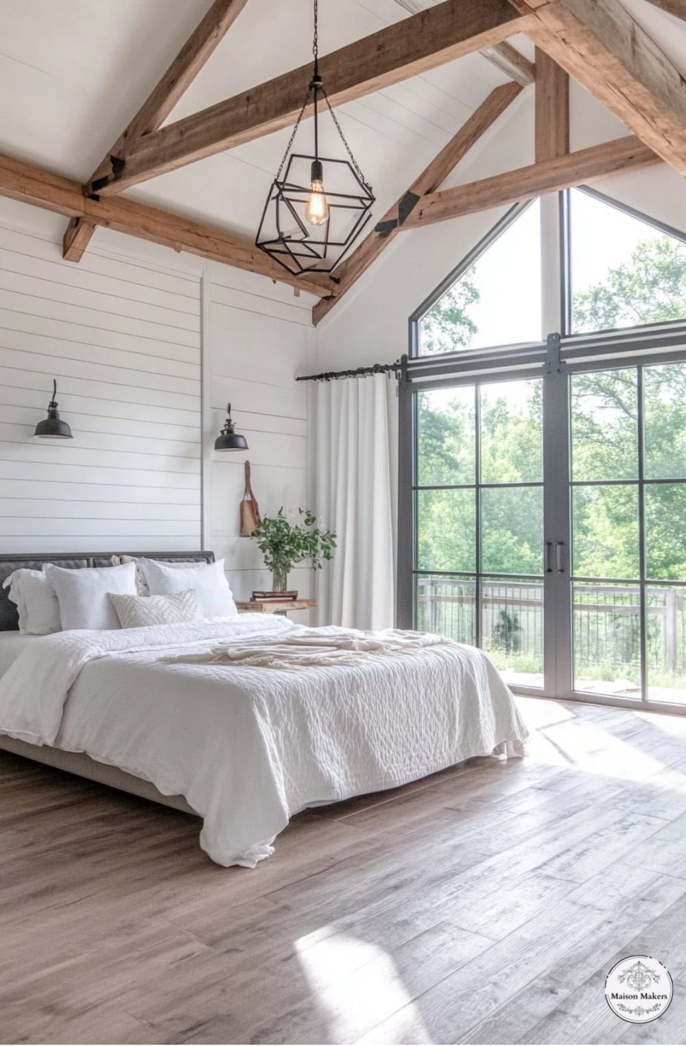 a bedroom with a large bed and a large window
