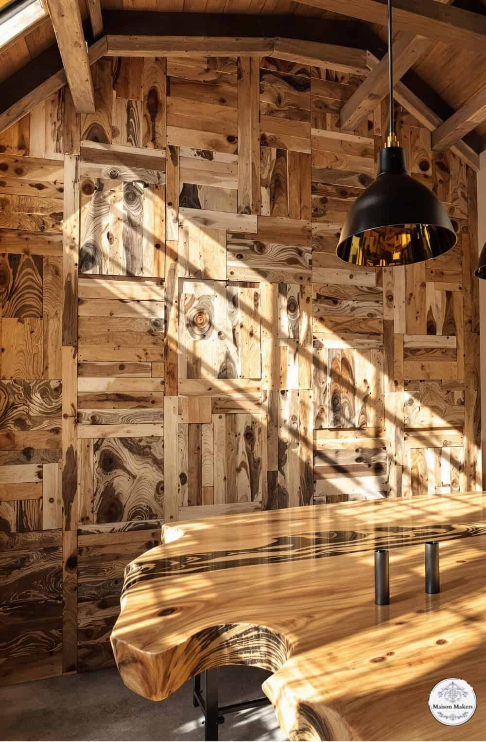 a wooden table sitting in a room under a light fixture