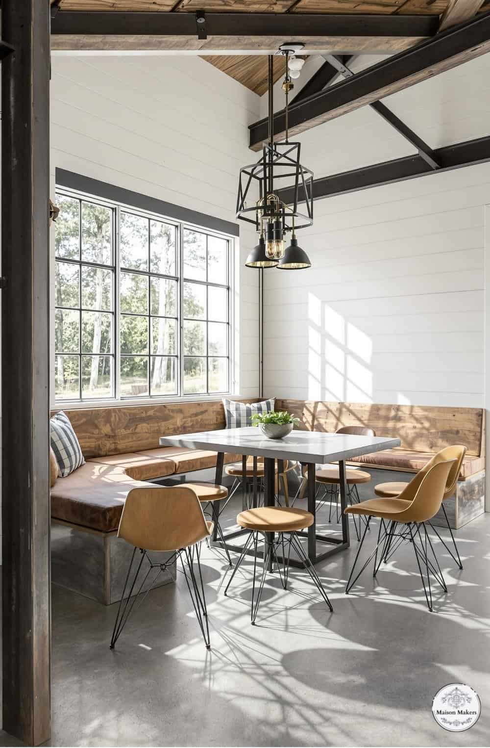 a room with a table, chairs and a bench