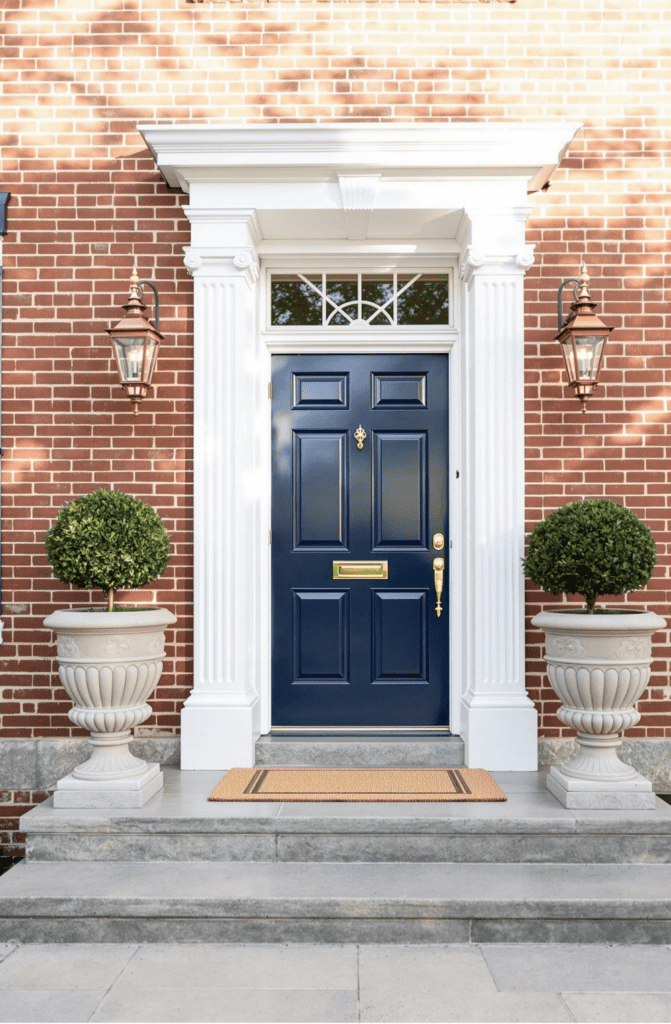 a blue front door on a brick building