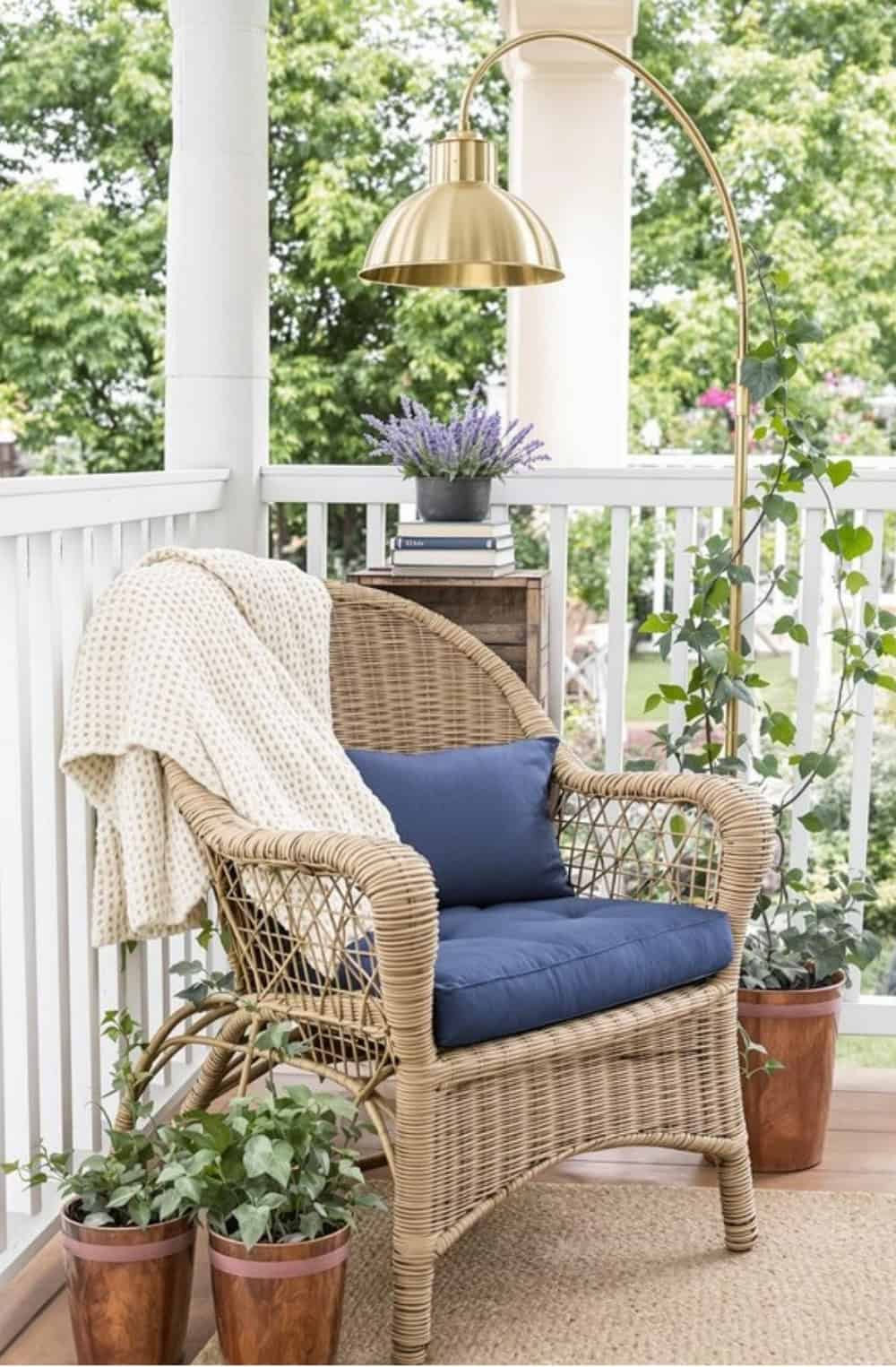 a wicker chair on a porch with a blue cushion