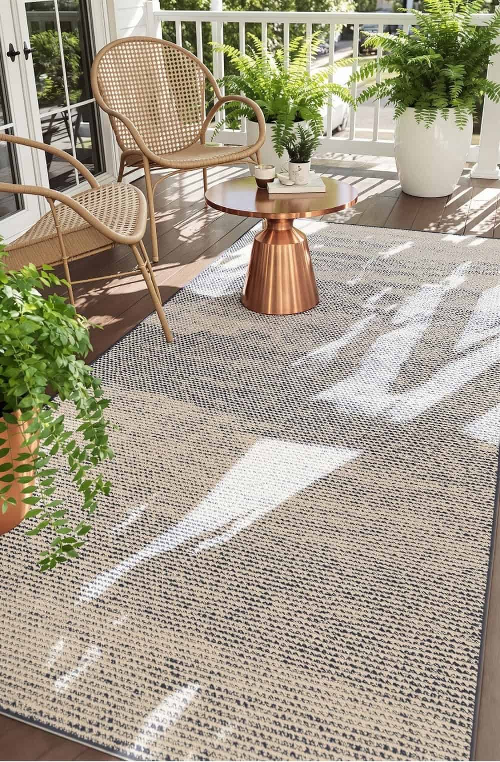 a patio area with a chair, table and potted plants