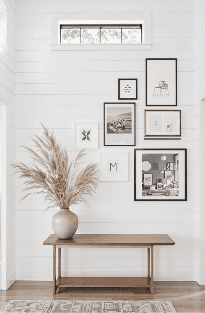 a vase with a plant on top of a wooden table