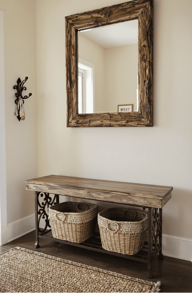 a wooden table with two baskets under a mirror
