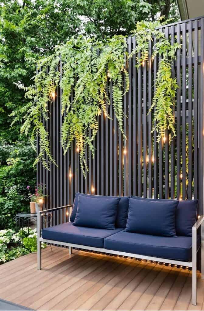 a blue couch sitting on top of a wooden deck