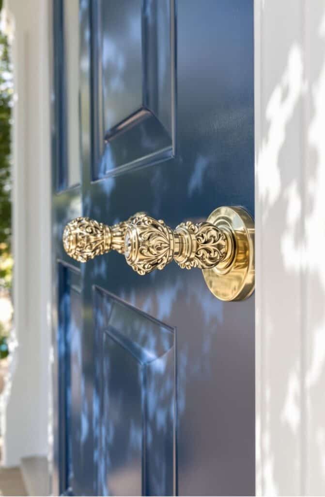 a close up of a door handle on a blue door