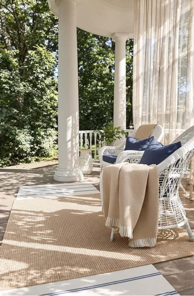 a porch with a chair and a blanket on it