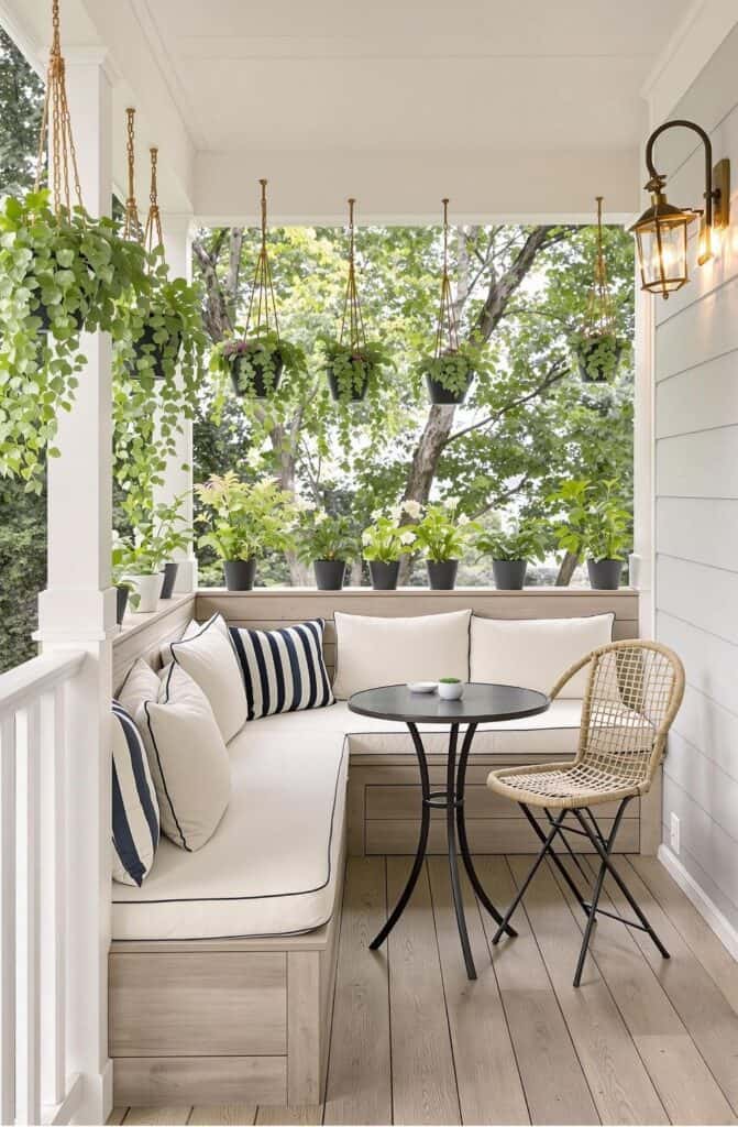 a porch with a white couch, table and chairs