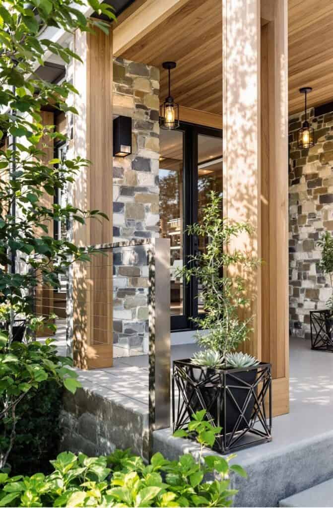 a porch with a stone wall and planters