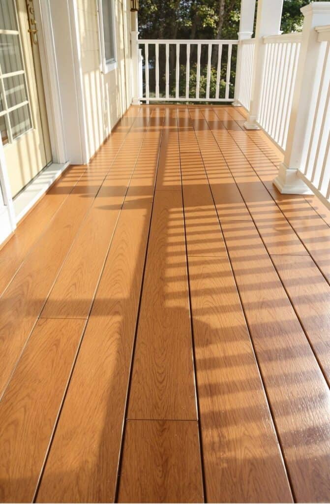 a wooden porch with white railing and white railing