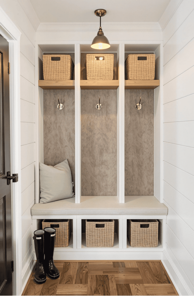 a mud room with a bench and some baskets