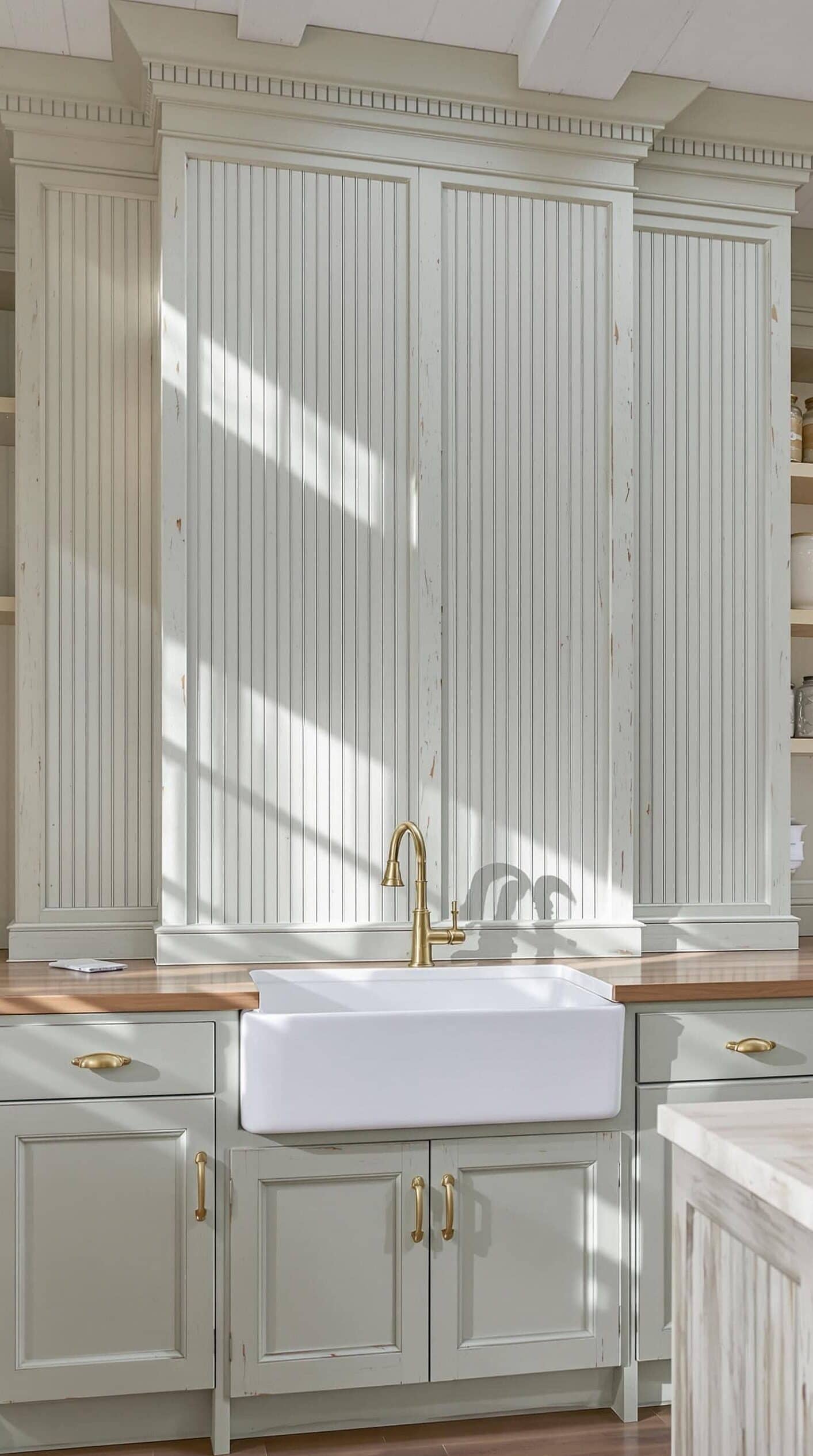 a kitchen with a sink, cabinets and a window