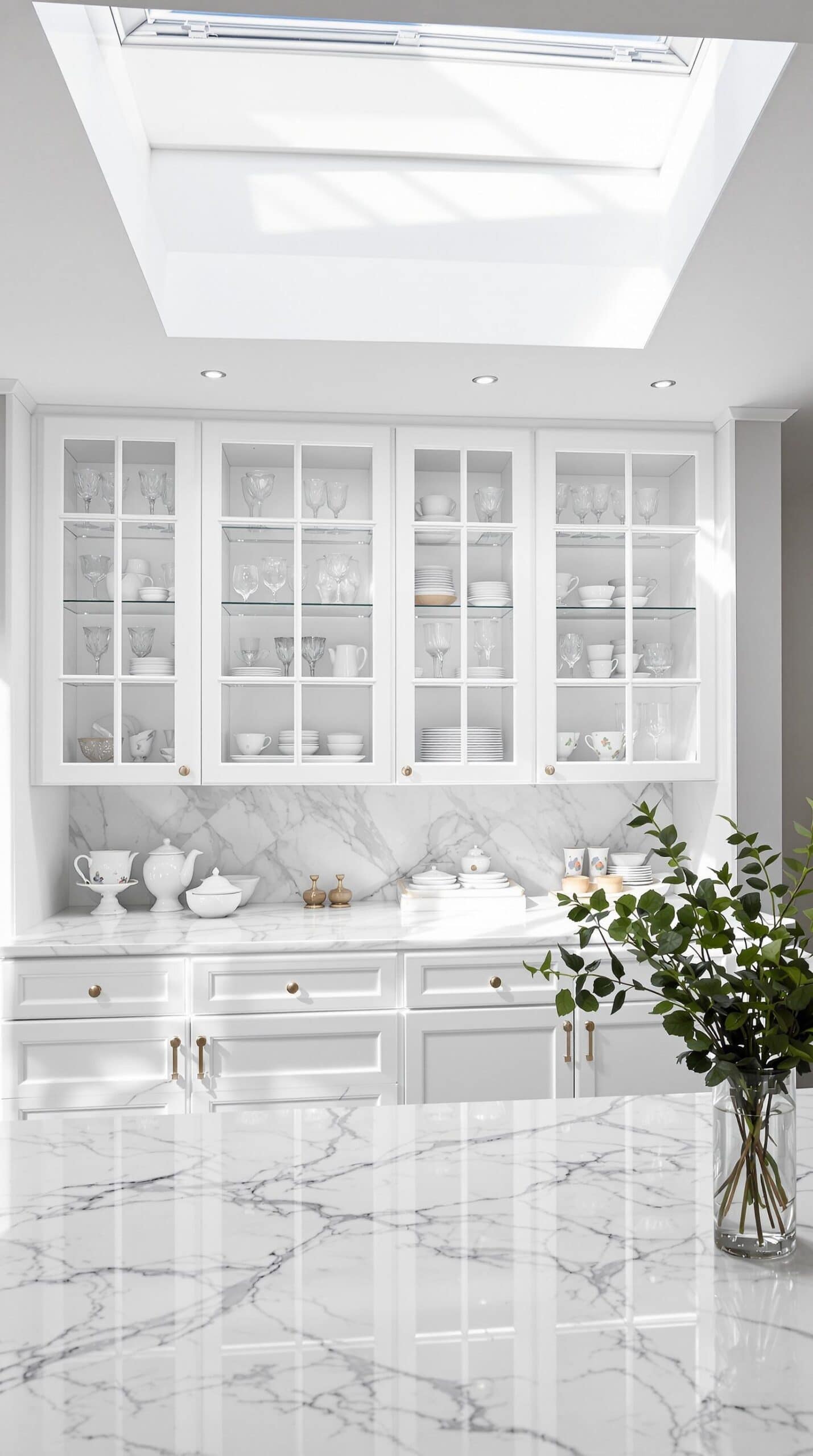 a kitchen with marble counter tops and white cabinets
