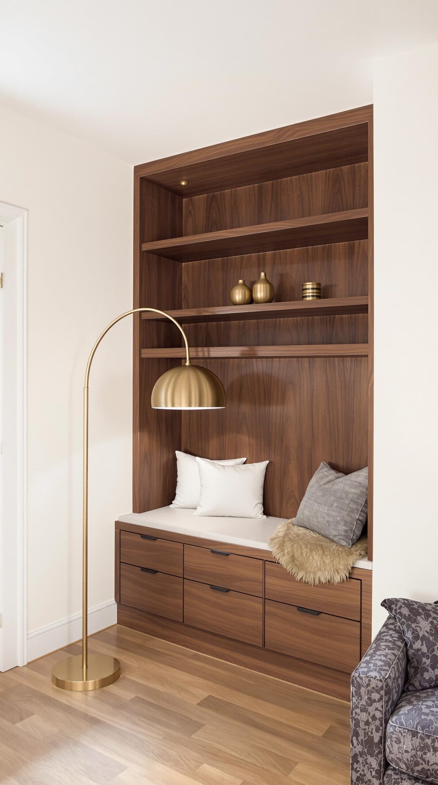 a living room with a couch and a book shelf