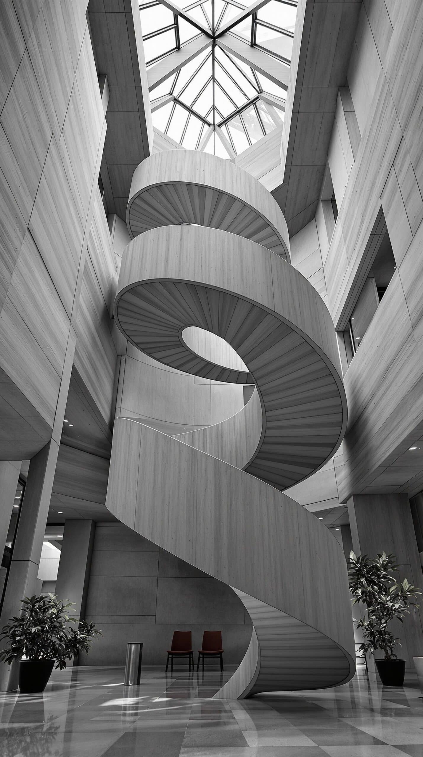 a spiral staircase in a building with a skylight