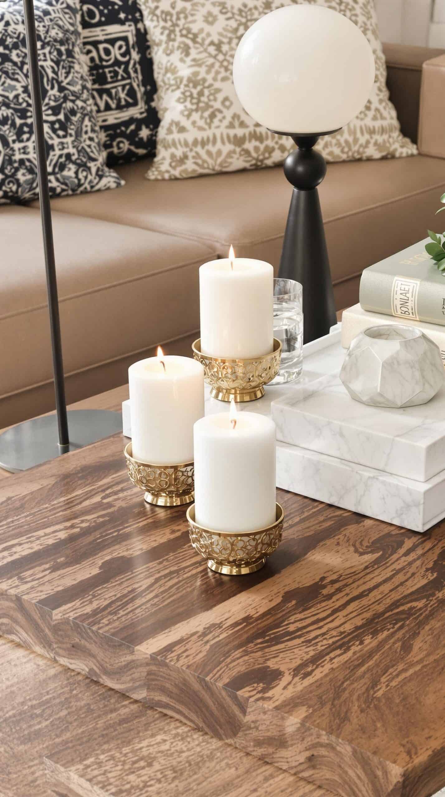 a coffee table with three candles on top of it