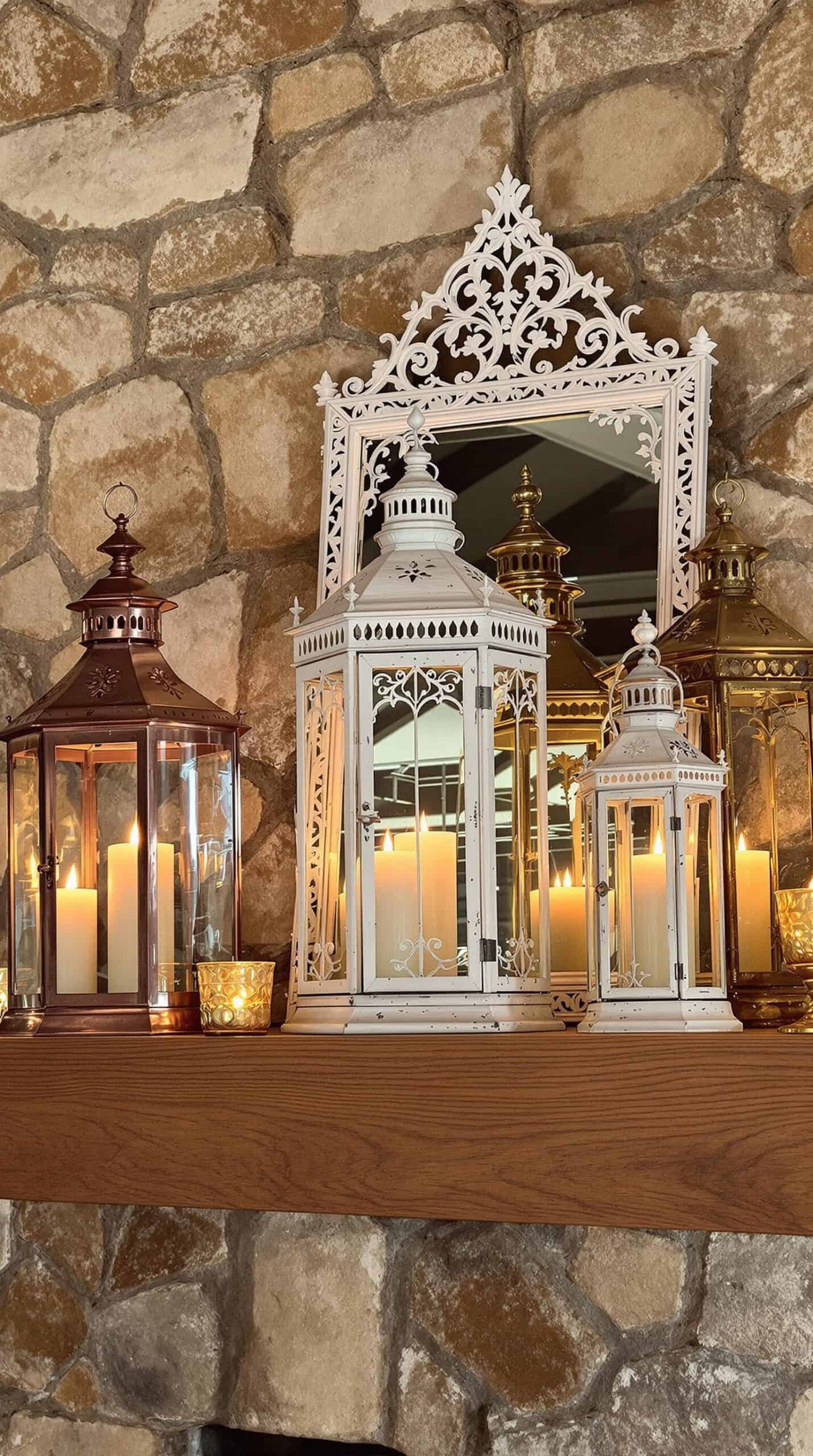a mantle with candles and lanterns on top of it