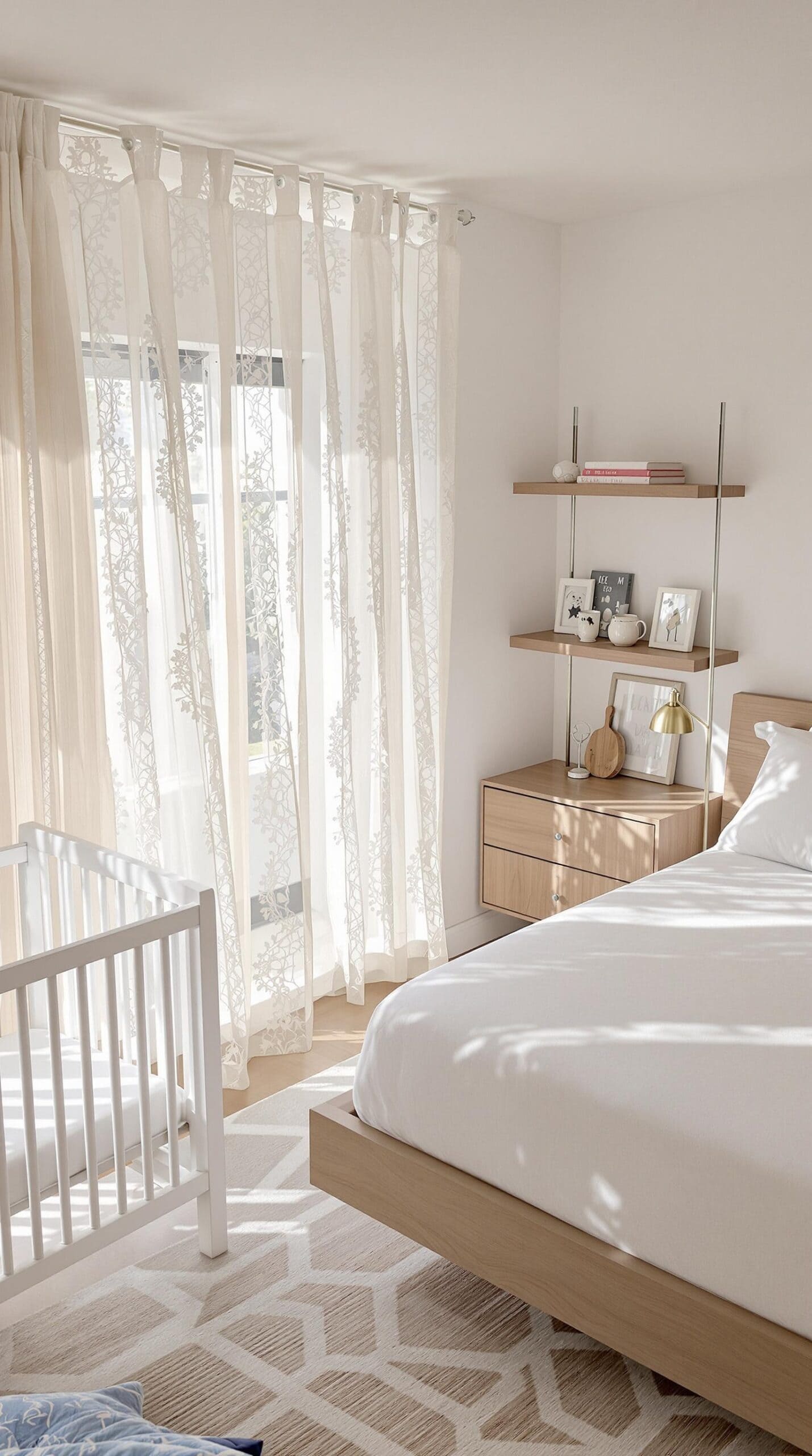 a baby's room with a crib, dresser, and window