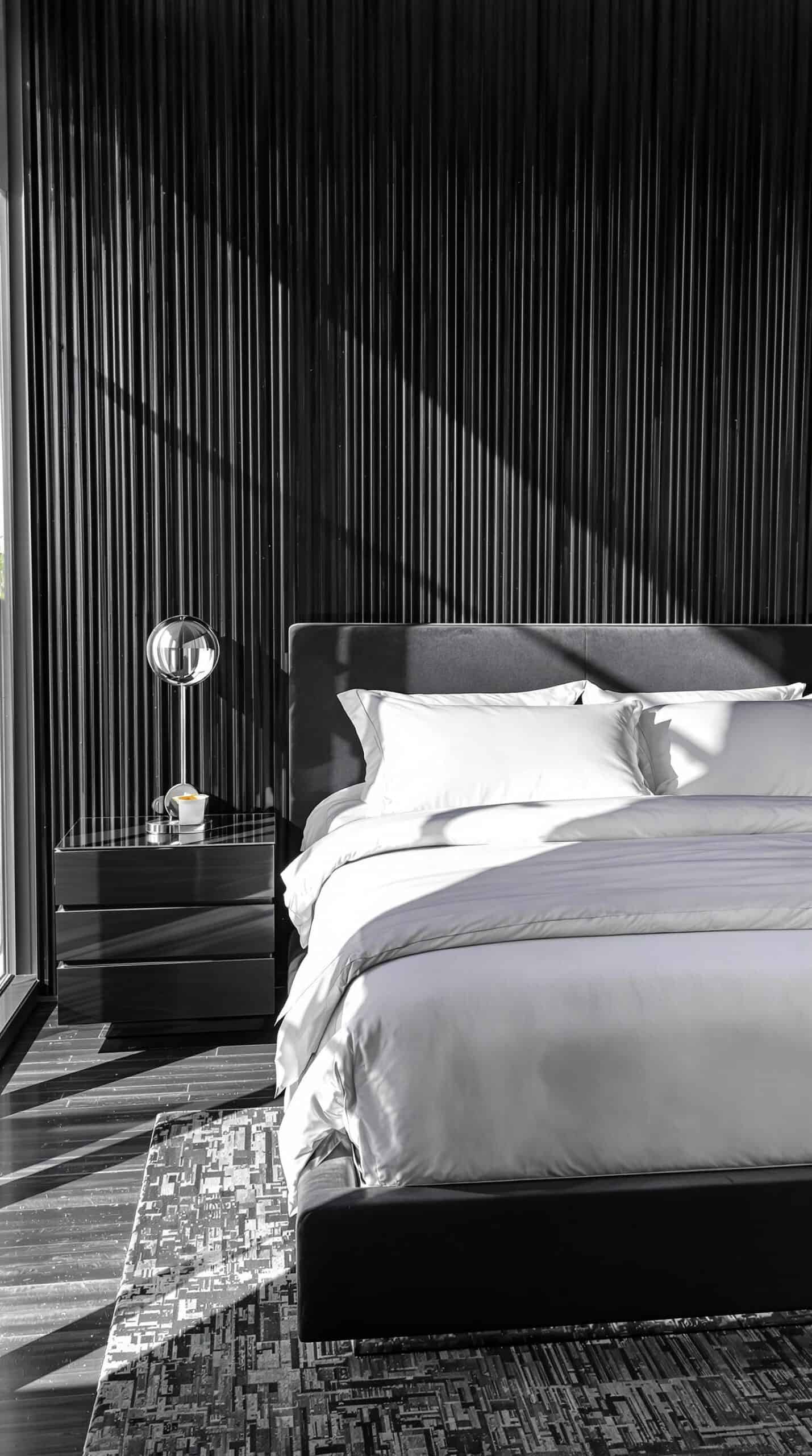 a bedroom with a large bed and a window