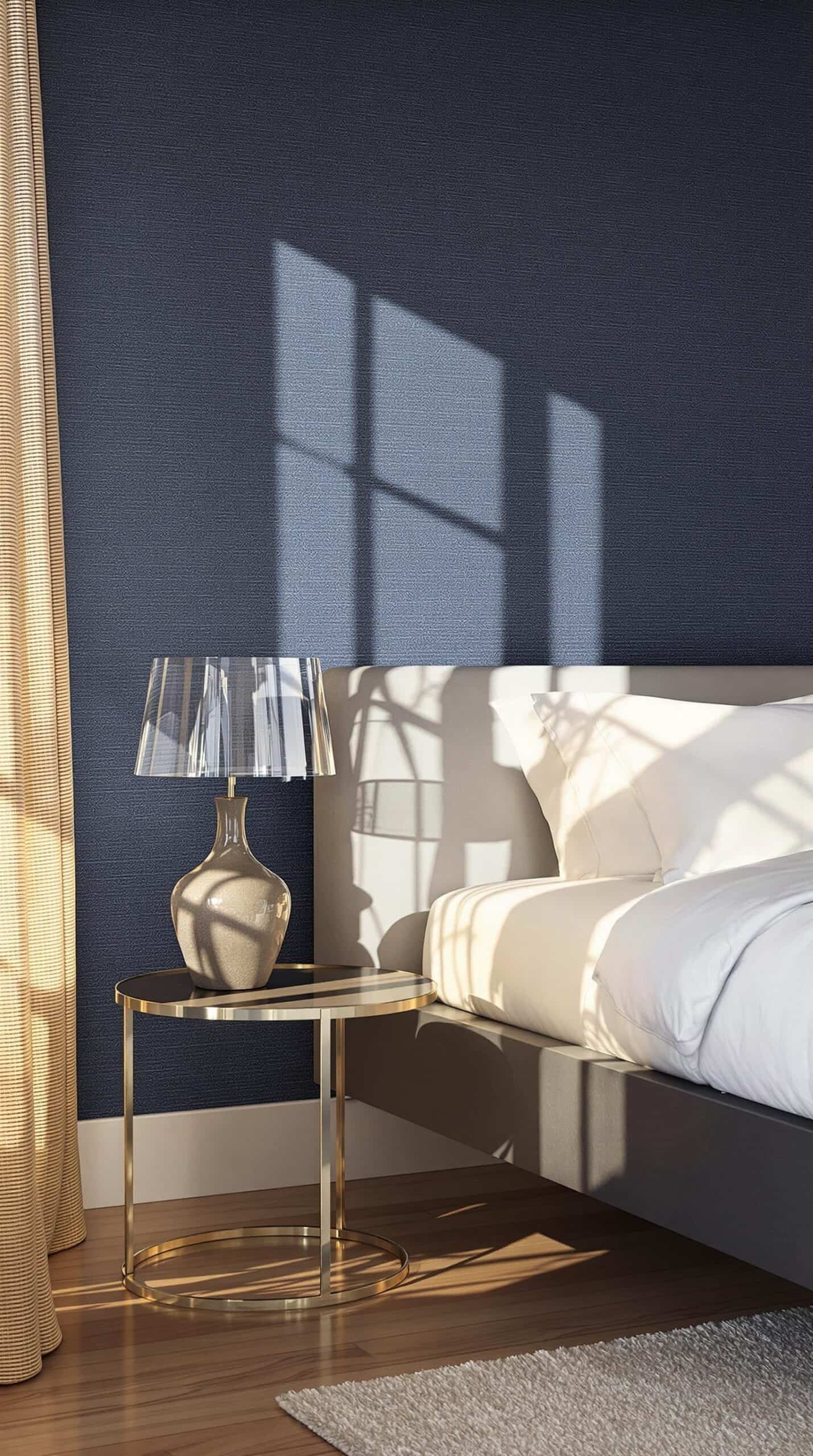 a bedroom with a bed and a lamp on a table